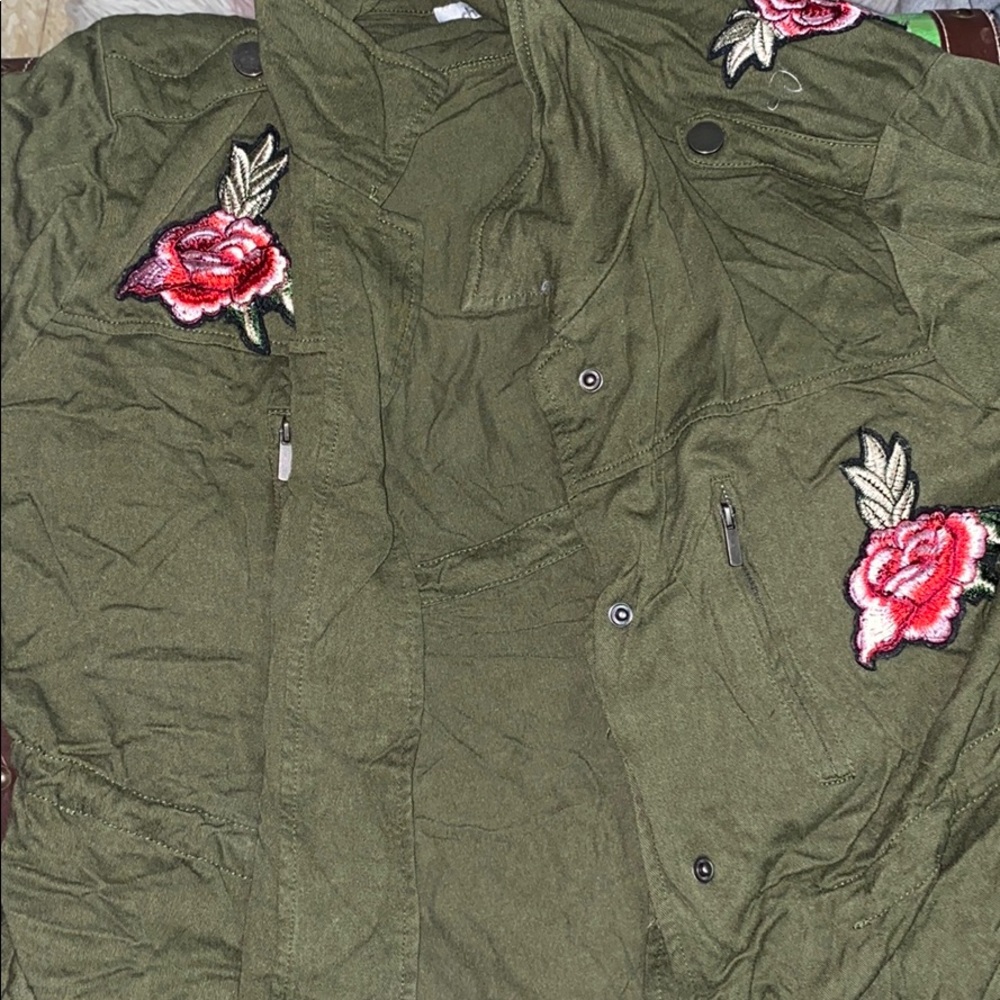 A green cardigan with roses on front and back